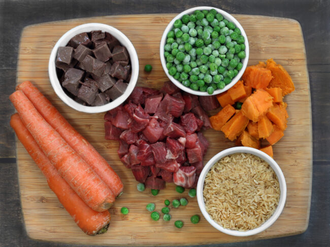 Ingredients for dog food on a cutting board